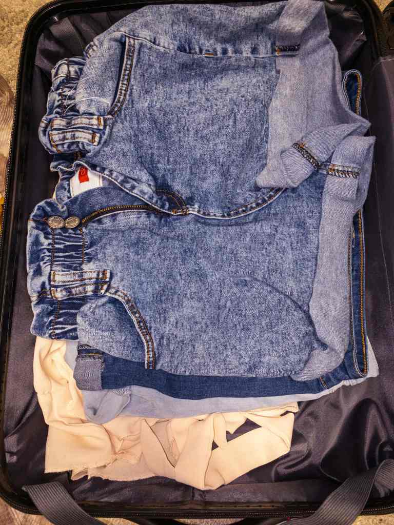 packing pants and shorts in a suitcase