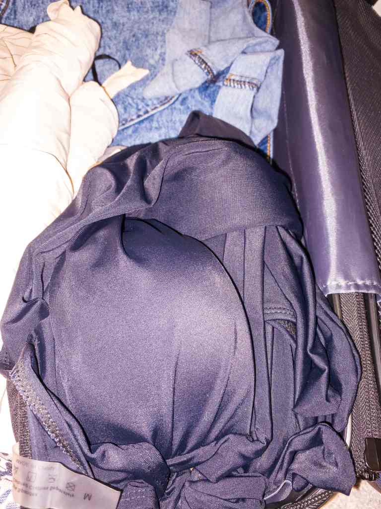 packing swimsuits in a suitcase